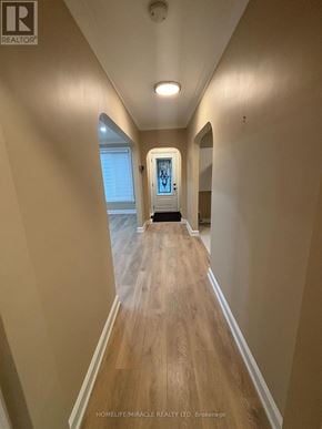 Vaughan (Vaughan Grove) apartment for rent - A long hallway with wood floors and white walls.