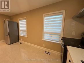 Vaughan (Vaughan Grove) apartment for rent - A kitchen with a refrigerator, a window with blinds, and a countertop.