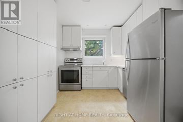 Toronto (Islington-City Centre West) apartment for rent - A kitchen with white cabinets and a refrigerator.