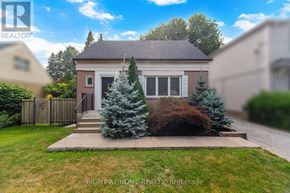 Toronto (Islington-City Centre West) apartment for rent - A house with a front yard and a tree in front of it.