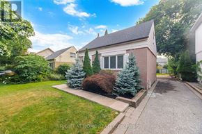 Toronto (Islington-City Centre West) apartment for rent - A house with a driveway and a lawn in front of it.
