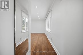 Toronto (Islington-City Centre West) apartment for rent - A spacious room with wooden floors and white walls.