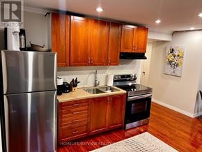 Vaughan (Patterson) apartment for rent - A kitchen with wooden cabinets and a stainless steel refrigerator.