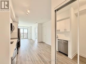 Toronto (Yorkdale-Glen Park) condo for rent - A kitchen with a refrigerator, sink, and cabinets.