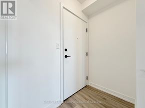 Toronto (Yorkdale-Glen Park) condo for rent - A white door with a black handle is in a room with white walls.
