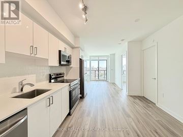 Toronto (Yorkdale-Glen Park) condo for rent - A kitchen with white cabinets and a wooden floor.