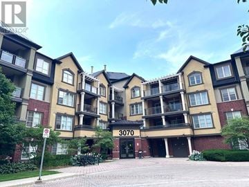 Burlington (Alton) condo for rent - The image shows a multi-story residential building with a no parking sign in front.