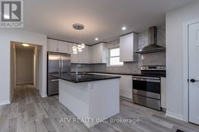 Mississauga (Lakeview) apartment for rent - A modern kitchen with a center island and stainless steel appliances.