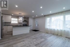 Mississauga (Lakeview) apartment for rent - A spacious kitchen and living room with wooden flooring and white walls.