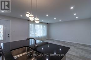 Mississauga (Lakeview) apartment for rent - A modern kitchen with a stainless steel sink and pendant lights.