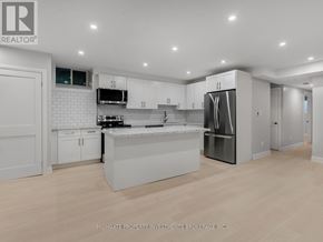 Toronto (Palmerston-Little Italy) apartment for rent - A modern kitchen with white cabinets and stainless steel appliances.