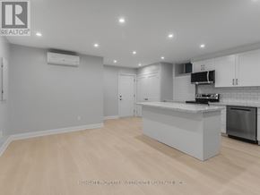 Toronto (Palmerston-Little Italy) apartment for rent - A modern kitchen with a white island and wooden flooring.