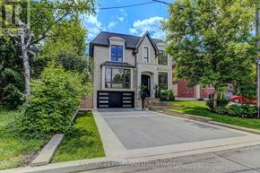 Toronto (Willowdale West) apartment for rent - A house with a driveway and a car parked on the side.