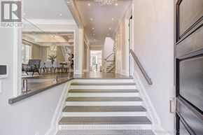 Toronto (Willowdale West) apartment for rent - A staircase with a grey and white carpeted runner leads to a brightly lit hallway.