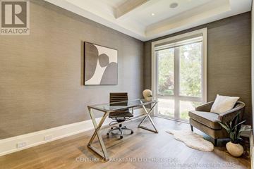 Toronto (Willowdale West) apartment for rent - A modern living room with a glass table and a brown couch.