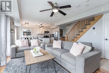 Collingwood townhouse for rent - A living room with a grey couch and a coffee table.