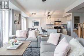 Collingwood townhouse for rent - A living room with a grey couch and a coffee table.