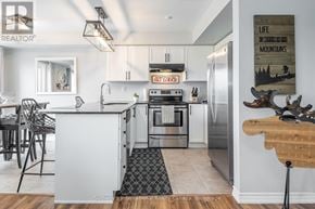 Collingwood townhouse for rent - A modern kitchen with a white island and stainless steel appliances.