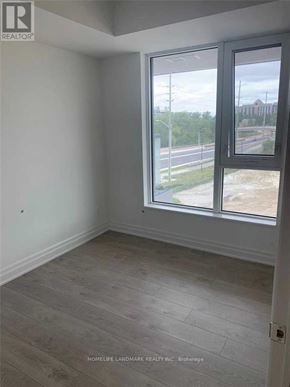 Markham (Unionville) condo for rent - A room with a large window and wooden flooring.