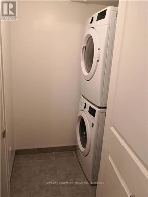 Markham (Unionville) condo for rent - A white washer and dryer in a small laundry room.