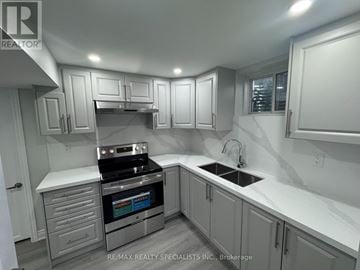 Caledon apartment for rent - A modern kitchen with white cabinets and a stainless steel oven.
