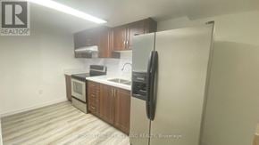 Markham (Milliken Mills East) apartment for rent - A kitchen with a refrigerator, microwave, and oven.