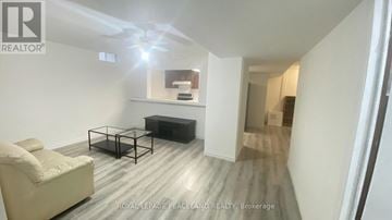 Markham (Milliken Mills East) apartment for rent - A living room with a white couch and a glass coffee table.