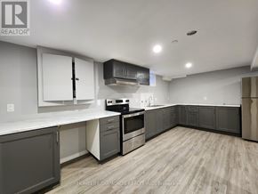 Thorold (Confederation Heights) apartment for rent - A kitchen with a white countertop and wooden flooring.