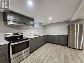 Thorold (Confederation Heights) apartment for rent - A kitchen with a stove top oven and a refrigerator.