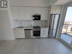 Hamilton (Corktown) condo for rent - A kitchen with white cabinets and stainless steel appliances.