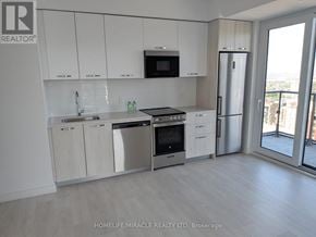 Hamilton (Corktown) condo for rent - A kitchen with white cabinets and stainless steel appliances.