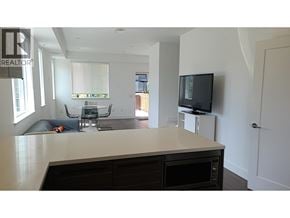 Richmond townhouse for rent - A modern kitchen with a white countertop and black cabinets.