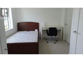 Richmond townhouse for rent - A bedroom with a bed, desk, and chair.