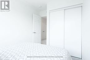 Milton (Cb Cobban) townhouse for rent - A bedroom with a bed, a door, and a wardrobe.