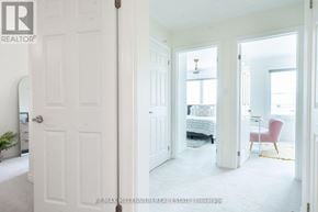 Milton (Cb Cobban) townhouse for rent - A white door is open to a room with a bed and a chair.