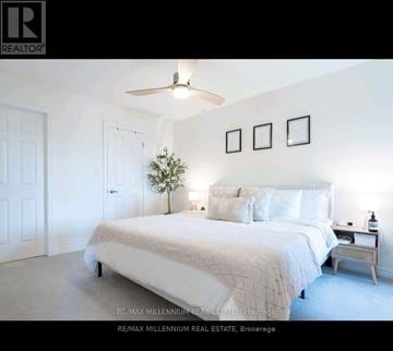 Milton (Cb Cobban) townhouse for rent - A bedroom with a large bed and a ceiling fan.