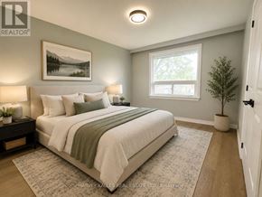 Toronto (Bendale) apartment for rent - A bedroom with a large bed and a painting on the wall.