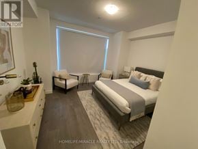 Brampton (Fletcher's Creek South) townhouse for rent - A bedroom with a bed, a chair, and a nightstand.