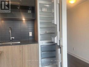 Toronto (Cabbagetown-South St. James Town) condo for rent - A kitchen with a sink and a refrigerator with the door open.
