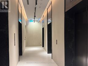 Toronto (Waterfront Communities) condo for rent - A hallway with doors on both sides and a sign that says "Dream Home Realty Inc., Brokerage.".