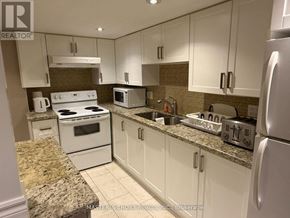 Newmarket (Woodland Hill) apartment for rent - A kitchen with white appliances and cabinets.