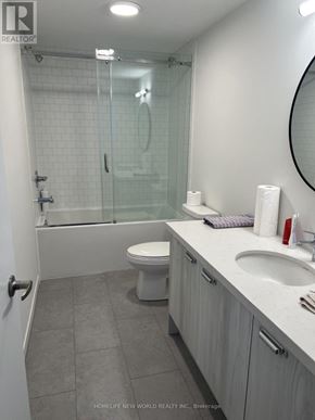 Richmond Hill apartment for rent - A bathroom with a toilet, sink, and shower.