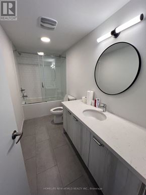 Richmond Hill apartment for rent - A white metal bed with a floral patterned cover.