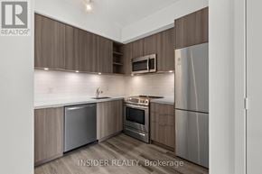 Toronto (Niagara) condo for rent - A modern kitchen with wooden cabinets and stainless steel appliances.