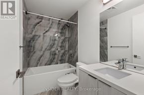 Toronto (Niagara) condo for rent - A modern bathroom with a marble shower and a white toilet.