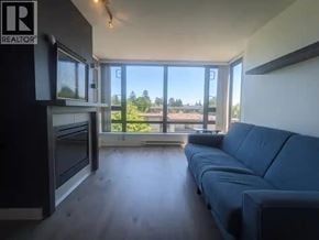 Burnaby apartment for rent - A living room with a blue couch and a television.