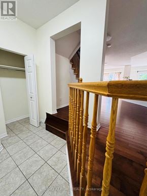 Ottawa townhouse for rent - A wooden staircase with a white door in the background.