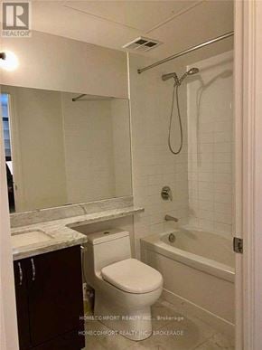 Markham (Unionville) condo for rent - A white bathroom with a toilet, sink, and bathtub.