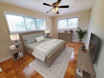 Hyattsville apartment for rent - A bedroom with a large bed and a ceiling fan.