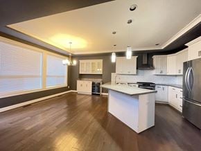 Langley apartment for rent - A kitchen with white cabinets and a wooden floor.